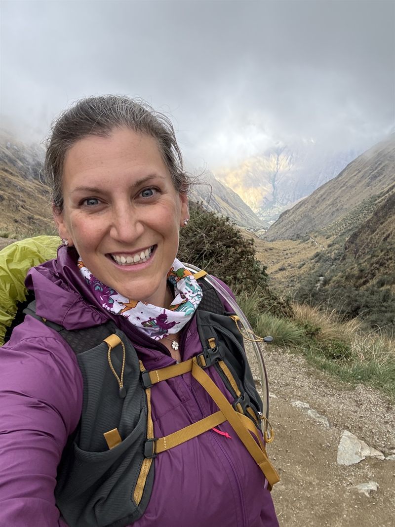 Amanda smiling on a misty mountain pass on the Inca Trail
