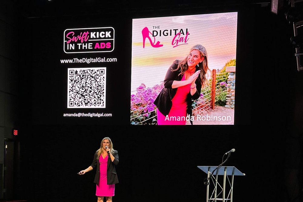 Amanda on stage at the Agents of Change Conference, with her Swift Kick in the Ads slide on the big screen